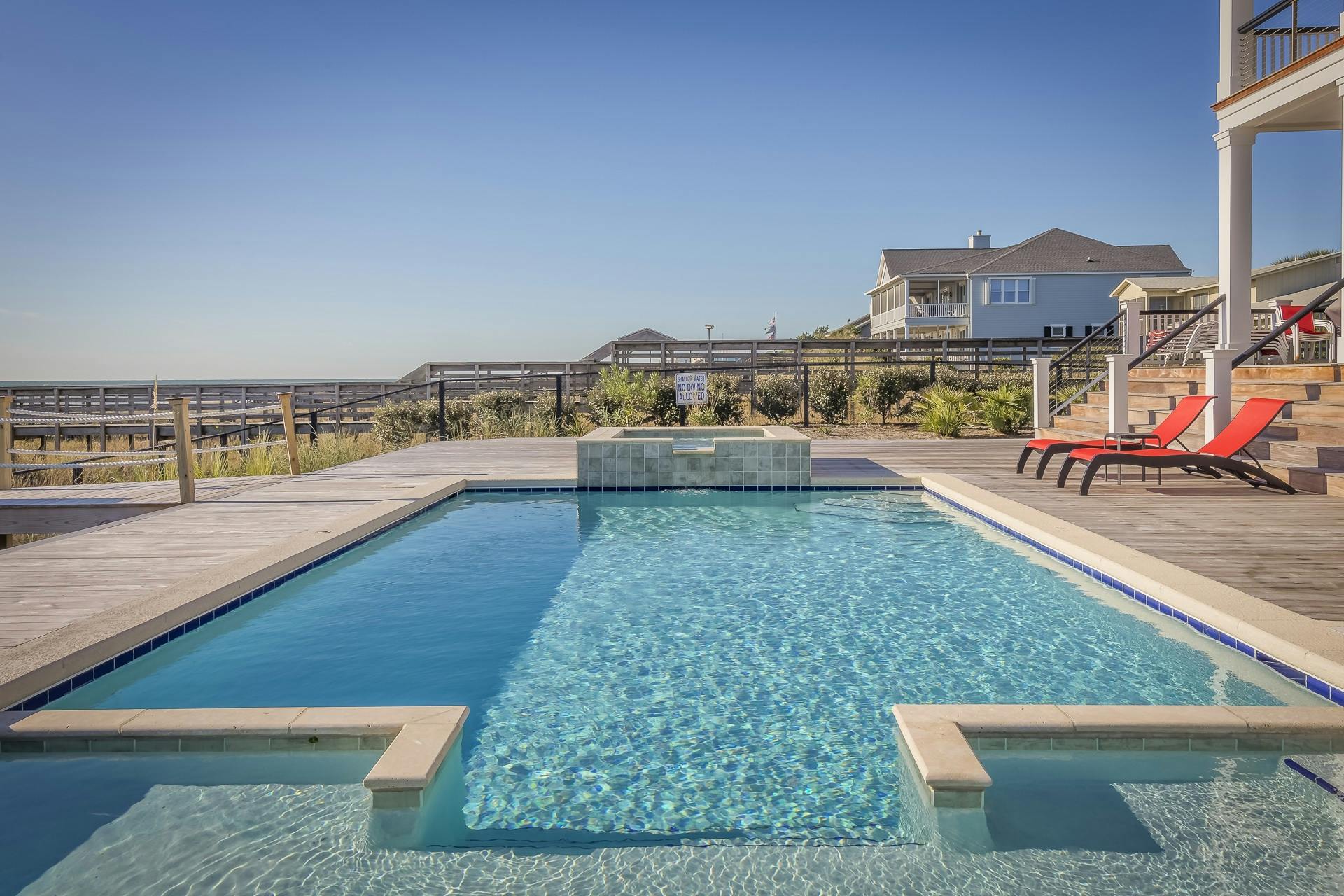 Pool coping and waterline detail at a backyard swimming pool